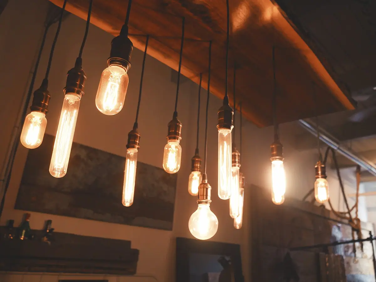 Cluster of warm Edison-style filament bulbs hanging from a wooden beam